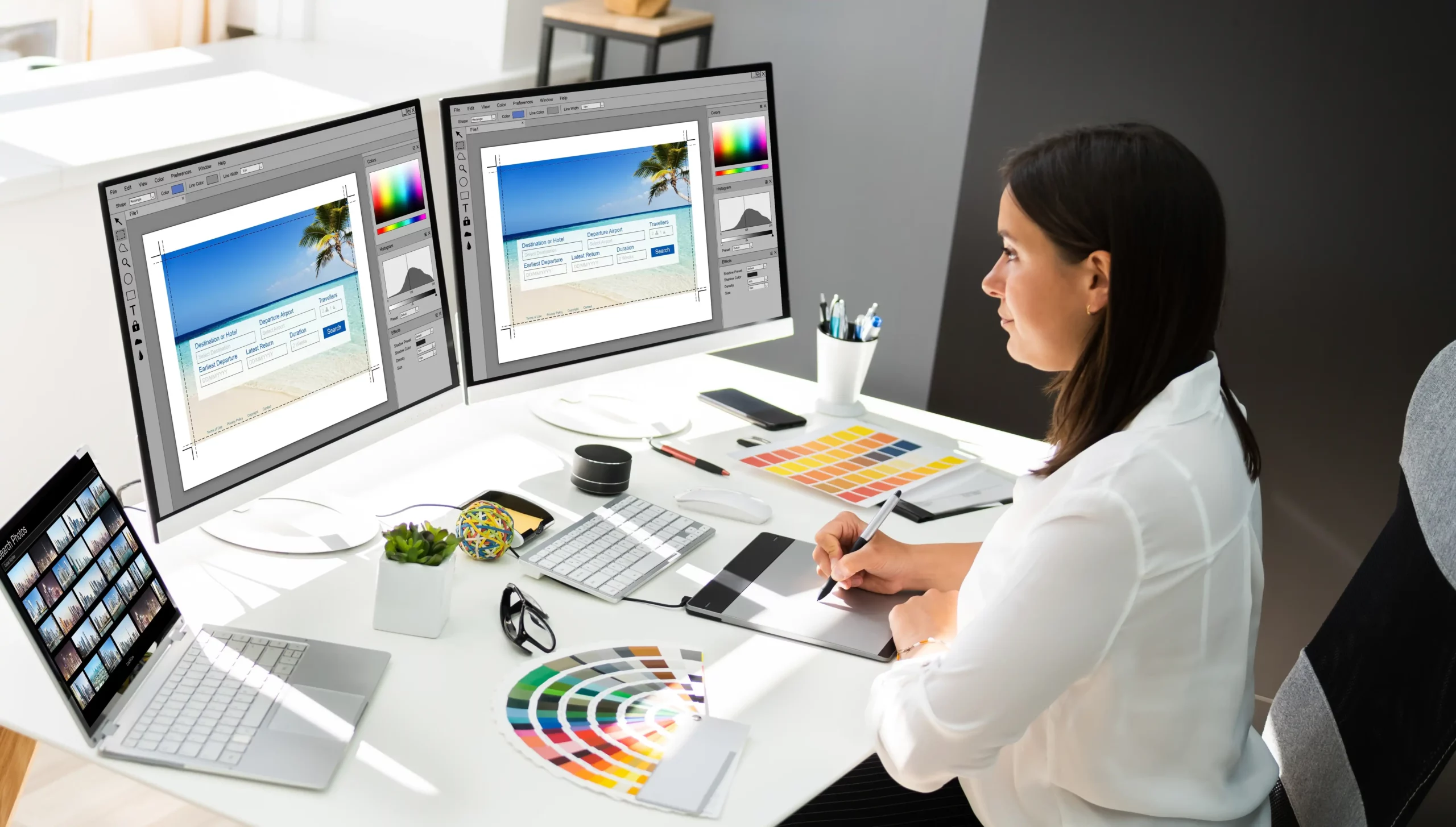 kcopy graphic designer artist working on multiple computer screens