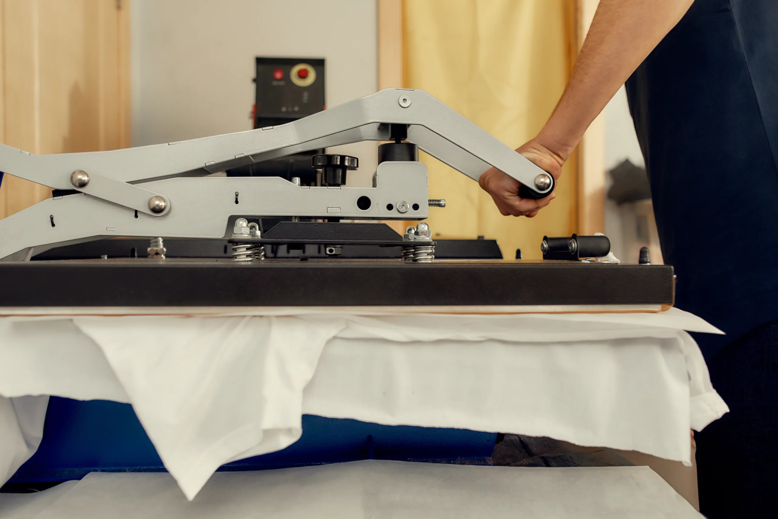 kcopycropped shot of male worker using heat press transfer machine for printing t shirt. printing on clothing and textiles concept. horizontal shot. side view