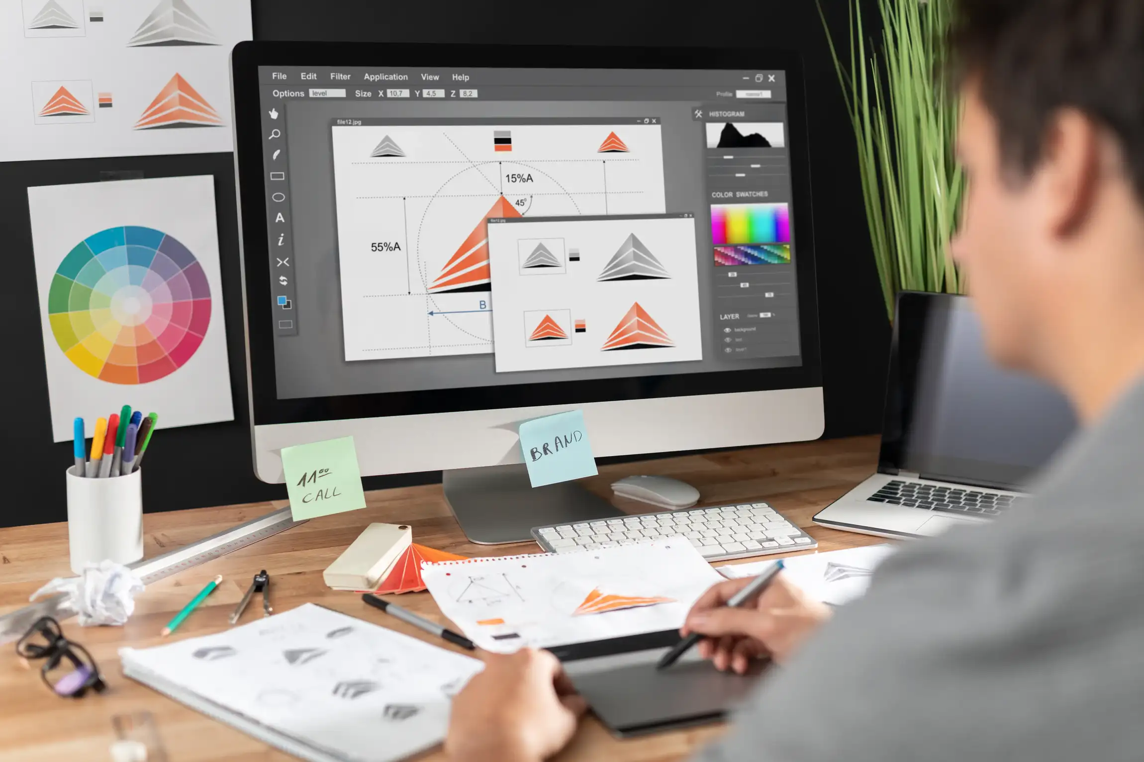 kcopygraphic designer drawing sketches logo design. the concept of a new brand. professional creative occupation with idea.